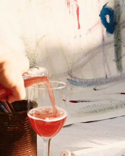 Minimum Alt Pet Nat bright wine red pouring from a bottle into a glass.